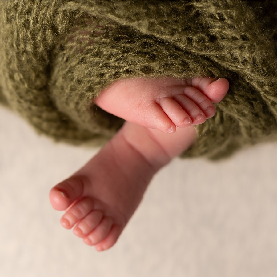 Baby feet wrapped in a blanket